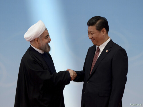 Iran’s President Rouhani shakes hands with his Chinese counterpart Xi before the opening ceremony of the CICA summit in Shanghai